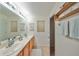 Light and airy bathroom with double sinks and linen storage at 12127 Luftburrow Ln, Hudson, FL 34669