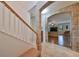 Bright entryway with hardwood floors, staircase, and archway leading to the living room at 12127 Luftburrow Ln, Hudson, FL 34669