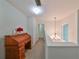 Upstairs hallway with chandelier and window at 12127 Luftburrow Ln, Hudson, FL 34669