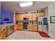 Kitchen with stainless steel appliances, wood cabinets, and granite countertops at 12127 Luftburrow Ln, Hudson, FL 34669