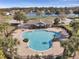 Community pool with a large deck and lounge chairs at 12127 Luftburrow Ln, Hudson, FL 34669