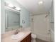 Well-lit bathroom featuring a vanity with sink, toilet, and a shower-tub combination with subway tile surround at 1236 Live Oak Ln, Lutz, FL 33558