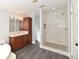 Elegant bathroom showcasing a walk-in shower, vanity with sink, and sleek tile flooring at 1236 Live Oak Ln, Lutz, FL 33558