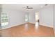 Spacious bedroom featuring wood-look floors, a ceiling fan, and natural light from the windows at 1236 Live Oak Ln, Lutz, FL 33558