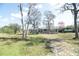 Inviting single-story home featuring mature trees and a well-maintained lawn at 1236 Live Oak Ln, Lutz, FL 33558