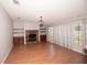 Inviting living room with a stone fireplace, built-in shelving, and large windows at 1236 Live Oak Ln, Lutz, FL 33558