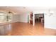 Bright living room featuring wood-look floors, a ceiling fan, and a large window at 1236 Live Oak Ln, Lutz, FL 33558