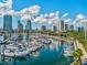 Aerial view of marina with numerous boats and city skyline in background at 146 4Th Ne Ave # 504, St Petersburg, FL 33701