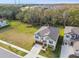 Aerial view of a two-story house with a gray roof and attached garage, nestled in a quiet community at 14690 Horse Trot Rd, Lithia, FL 33547