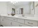 Bathroom with double vanity, white cabinets, and large mirror at 14690 Horse Trot Rd, Lithia, FL 33547