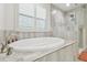 Oval soaking tub and walk-in shower in bathroom at 14690 Horse Trot Rd, Lithia, FL 33547