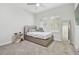 Bedroom with gray carpet, window shutters and a full-size bed at 14690 Horse Trot Rd, Lithia, FL 33547