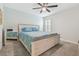 Bedroom with a queen bed, ceiling fan, and large window with plantation shutters at 14690 Horse Trot Rd, Lithia, FL 33547