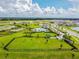 Aerial view of a community park with a dog park, playground, and picnic area at 14690 Horse Trot Rd, Lithia, FL 33547