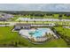 Aerial view of a resort-style community pool with lounge chairs and a pergola at 14690 Horse Trot Rd, Lithia, FL 33547