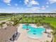 Aerial view of community pool with spacious deck and lounge chairs at 14690 Horse Trot Rd, Lithia, FL 33547