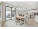 Dining area with wooden table, view into kitchen and backyard at 14690 Horse Trot Rd, Lithia, FL 33547