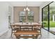 Bright dining room with wooden table, bench, and view of backyard at 14690 Horse Trot Rd, Lithia, FL 33547