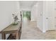 Bright and airy entryway with tile floors and a console table at 14690 Horse Trot Rd, Lithia, FL 33547