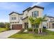 Two-story house with stone accents and palm trees at 14690 Horse Trot Rd, Lithia, FL 33547