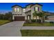 Two-story home with stone accents and a three-car garage at 14690 Horse Trot Rd, Lithia, FL 33547