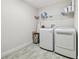 Laundry room with washer, dryer, and overhead shelving at 14690 Horse Trot Rd, Lithia, FL 33547