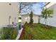 Landscaped backyard with AC units and storage shed at 1740 W Saint Louis St, Tampa, FL 33607