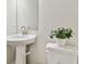 Modern bathroom featuring pedestal sink and updated fixtures at 1740 W Saint Louis St, Tampa, FL 33607