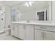 Elegant bathroom with white cabinets and a large mirror at 1740 W Saint Louis St, Tampa, FL 33607