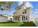 Tan three-story house with covered patio and fenced yard at 1740 W Saint Louis St, Tampa, FL 33607