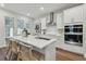 Bright kitchen featuring white cabinets, stainless steel appliances, and an island with seating at 1740 W Saint Louis St, Tampa, FL 33607