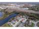 Aerial view of a house in a quiet residential neighborhood near a lake at 17436 Lawn Orchid Loop, Land O Lakes, FL 34638