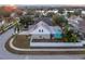 Aerial view of a house near a lake at 17436 Lawn Orchid Loop, Land O Lakes, FL 34638