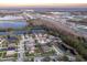 Aerial view highlighting a house's location near a lake and highway at 17436 Lawn Orchid Loop, Land O Lakes, FL 34638