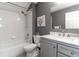 Bathroom with a white bathtub, gray vanity, and marble countertop at 17436 Lawn Orchid Loop, Land O Lakes, FL 34638