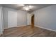 Bright bedroom featuring wood-look floors and a ceiling fan at 17436 Lawn Orchid Loop, Land O Lakes, FL 34638