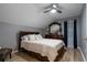 Cozy bedroom with wood-look floors and ceiling fan at 17436 Lawn Orchid Loop, Land O Lakes, FL 34638