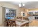 Bright dining room with table and chairs, overlooking the pool at 17436 Lawn Orchid Loop, Land O Lakes, FL 34638