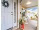 Front entry with white door and potted plants at 17436 Lawn Orchid Loop, Land O Lakes, FL 34638