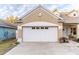 Two-car garage with white door at 17436 Lawn Orchid Loop, Land O Lakes, FL 34638