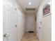 Light hallway with tile flooring and multiple closets at 17436 Lawn Orchid Loop, Land O Lakes, FL 34638