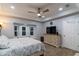 Main bedroom featuring a dresser, TV, and large windows at 17436 Lawn Orchid Loop, Land O Lakes, FL 34638