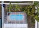 Aerial view of a kidney-shaped swimming pool with a screened enclosure at 17436 Lawn Orchid Loop, Land O Lakes, FL 34638