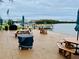 Community waterfront patio with picnic tables, grills, and a covered seating area at 1847 Shore S Dr # 316, South Pasadena, FL 33707