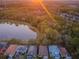 Aerial view of houses near a lake at sunset at 19144 Meadow Pine Dr, Tampa, FL 33647