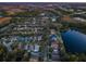 Aerial view of a residential neighborhood with houses, trees, and a lake at 19144 Meadow Pine Dr, Tampa, FL 33647