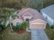 Property view showcasing house, driveway, and surrounding landscape at 19144 Meadow Pine Dr, Tampa, FL 33647