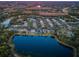 Aerial view of houses and lake with fall foliage at 19144 Meadow Pine Dr, Tampa, FL 33647