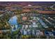 Aerial view of houses near a lake with lush green trees at 19144 Meadow Pine Dr, Tampa, FL 33647