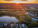 Aerial view of homes near a lake at sunset at 19144 Meadow Pine Dr, Tampa, FL 33647